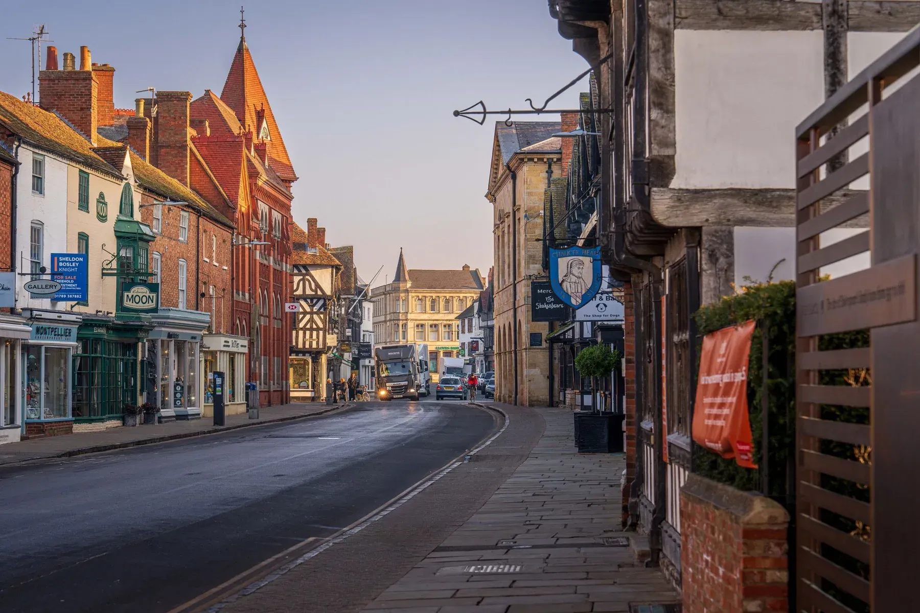 Timber-framed and red brick buildings along a Stratford-upon-Avon street at first light